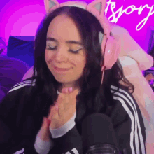 a woman wearing a cat ear headband is smiling
