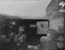 a black and white photo of soldiers with pathe written on the bottom right