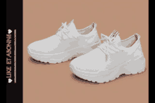 a pair of white sneakers with the words like et abonnes on the bottom