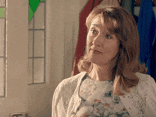 a woman in a floral dress and white cardigan