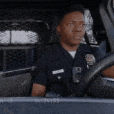 a police officer is sitting in a car with the time 14:34 55