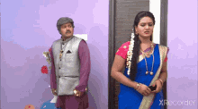 a man and a woman are standing next to each other in front of a door ..