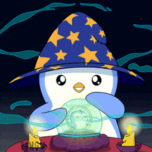 a penguin wearing a wizard 's hat is holding a crystal ball