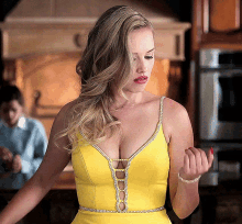 a woman in a yellow dress with rhinestones on the straps