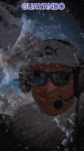 a man wearing headphones and sunglasses has the word guayando written above him