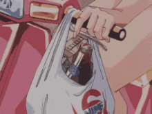 a person is holding a plastic bag with a bottle of soda and cigarettes in it while riding a scooter .