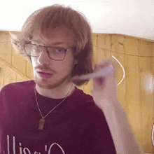 a man wearing glasses and a red shirt that says ' lions '