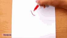 a person is drawing a line with a red marker on a piece of paper that says drawbook