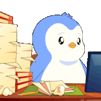 a blue and white penguin sits at a desk in front of a computer monitor
