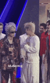 a group of people standing next to each other on a stage .