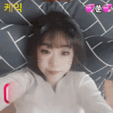 a girl with a cat ear on her head takes a picture of herself