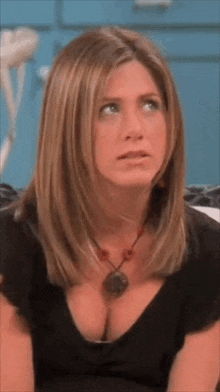 a woman is sitting on a couch with her breast exposed .