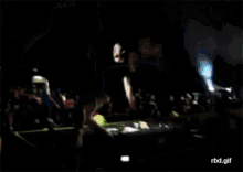 a blurry picture of a man laying on a stage with the words rbd.gif below