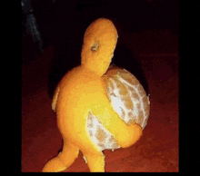 a stuffed animal made out of an orange with a hole in it