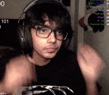 a man wearing headphones and glasses is playing a video game with the number 101 in the background