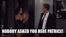 a man in a suit and tie is standing next to a woman in lingerie and says nobody asked you here patrice .