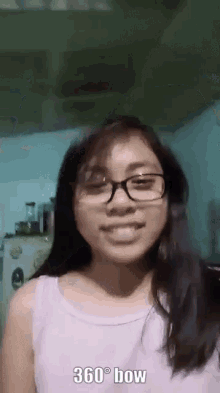 a girl wearing glasses and a purple shirt says 360 ° bow
