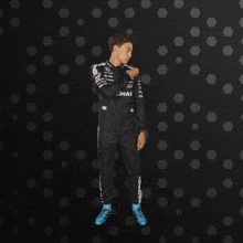 a man in a petronas racing suit is dancing