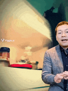 a man in a suit stands in front of a sign that says " viggle.ai "