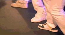 a close up of a person 's feet wearing white and black sneakers