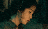 a woman wearing headphones is holding a red device that says sony on it
