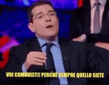a man in a suit and tie is saying " voi comunisti "