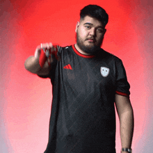 a man with a beard wearing an adidas shirt
