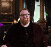 a man with glasses and a beard wearing a robe