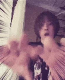 a close up of a person 's face with their hands outstretched in a room .