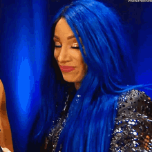 a woman with long blue hair is wearing a black and silver dress .