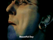 a close up of a woman 's face with the words beautiful day written below her