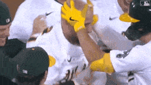 a group of baseball players wearing yellow nike gloves