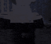 a man with a beard and a cross necklace is standing in front of a building .