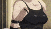 a close up of a woman 's torso and breasts in a black tank top