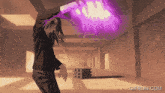 a gif from gifrun.com shows a person holding a purple object in their hand