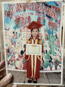 a picture of a little girl in a graduation cap and gown from 2011