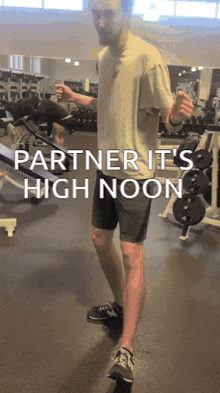 a man standing in a gym with the words partner it 's high noon