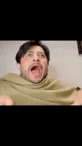 a man with a beard is making a funny face with his mouth wide open