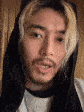 a man with a beard wearing a black hoodie
