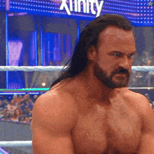 a man in a wrestling ring with the word xfinity in the back
