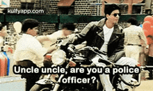 a man is riding a motorcycle in a crowded street and talking to another man .
