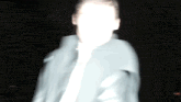 a blurry picture of a man 's face in the dark