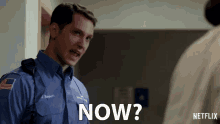 a man in a blue uniform says now