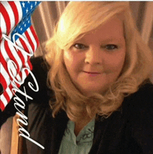 a woman stands in front of an american flag with the words " beyond " written on it