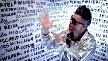 a man standing in front of a wall that says goodbye in many different languages