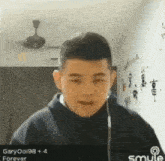 a young man wearing ear buds looks at the camera with garyooi98 + 4 forever written on the bottom right