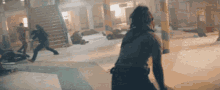 a woman is standing in a room with a bunch of people standing around her .