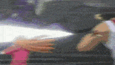 a blurry picture of a person holding another person 's hand with a white light coming out of it