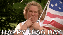 a woman blowing a kiss while holding an american flag with the words happy flag day above her