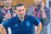 a man wearing a blue shirt with a argentina logo on the front